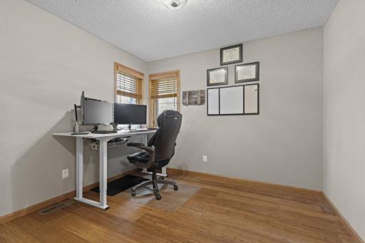 A main floor office, which could easily be used as a flex/creative room or den, features windows overlooking the front porch and views of the front yard.
