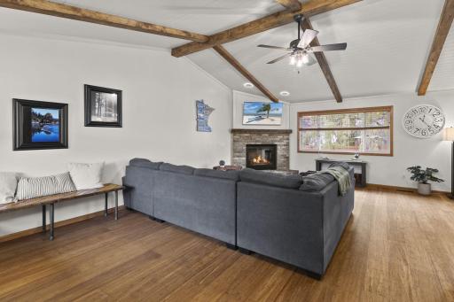 This spacious living area features paneled vaulted ceilings with exposed beams.