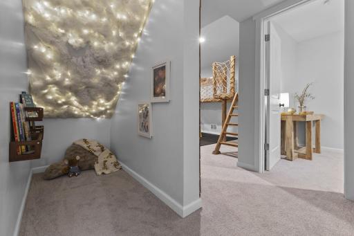 Around the corner, you'll find the under-stairs area converted into a reading nook, complete with a "simulated thunder" ceiling.