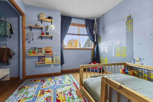 This bedroom also features shelving and an open access closet area.
