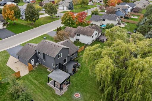 An aerial view of the large deck, pavilion, and usable backyard. The roof was replaced in 2018, and the siding was replaced in 2020.