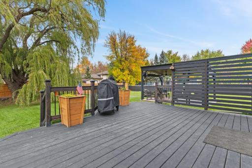 The dining area walks out to this platform deck, which features two sets of stairs cascading down, plus a great wood privacy screen.