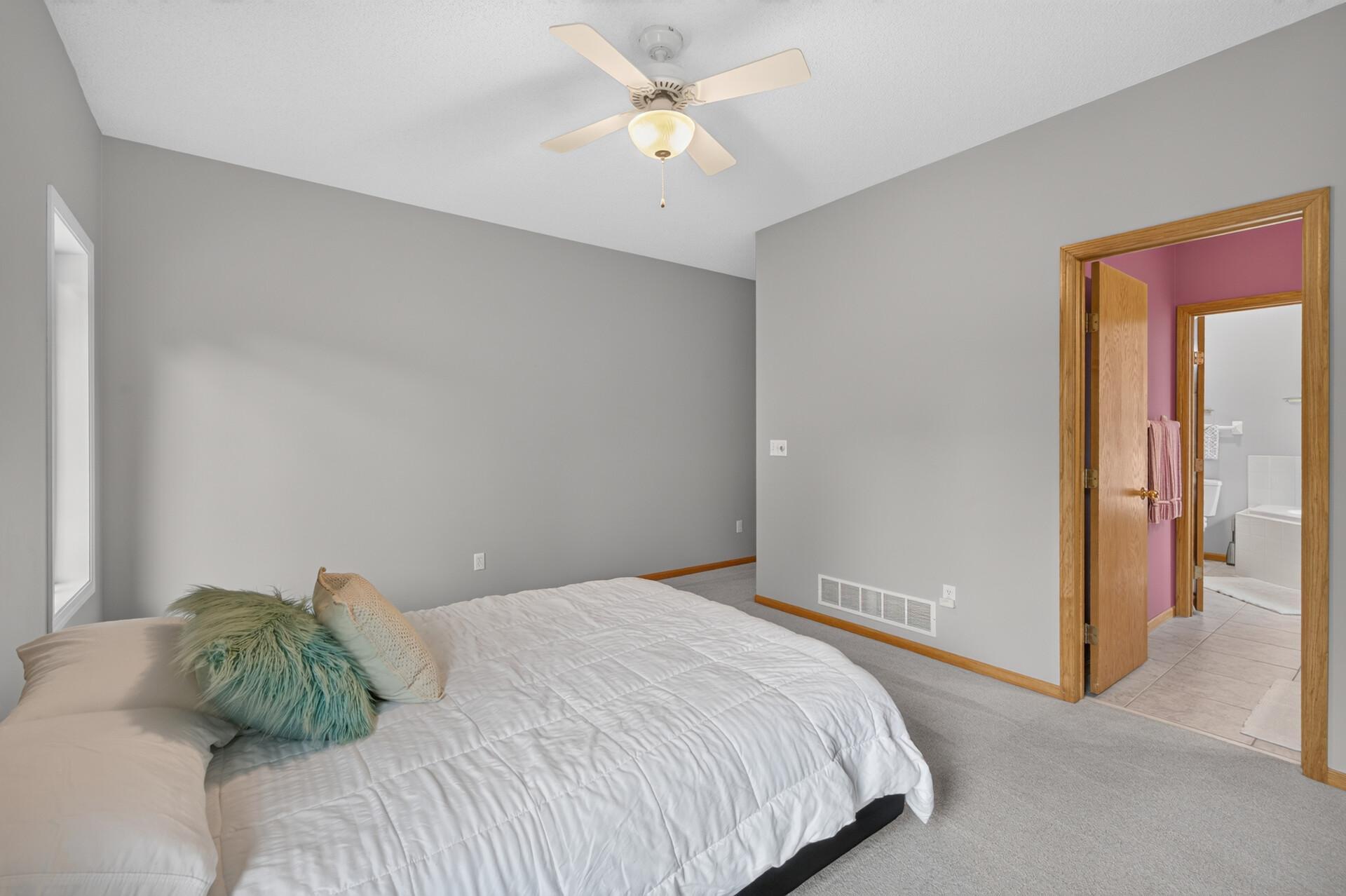 A view in the primary bedroom looking towards the walk in closet and 1/2 bath that walks through to the main bath.