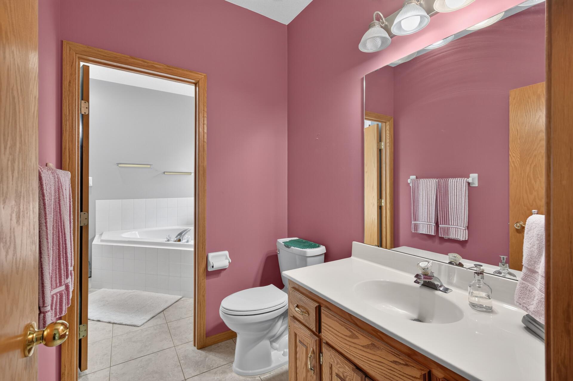 The primary bedroom has a 1/2 bath and a walk through to the main bathroom.