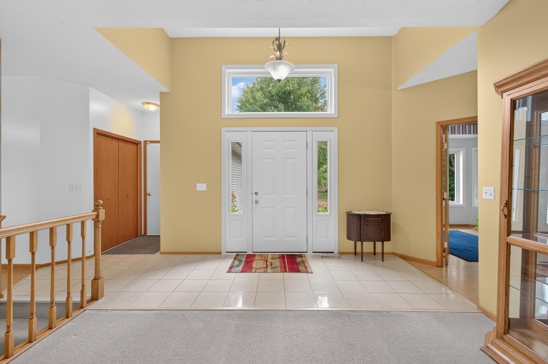 Big and bright foyer with gleaming ceramic tiled floor. There is a double sidelight and transom window over the front door for lots of natural light.