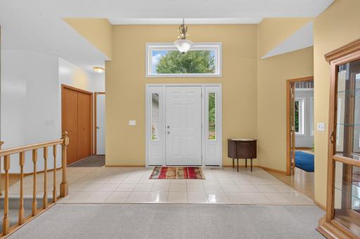 Big and bright foyer with gleaming ceramic tiled floor. There is a double sidelight and transom window over the front door for lots of natural light.
