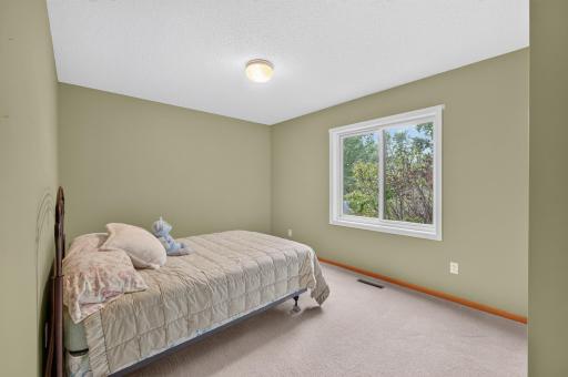 Bedroom # 3 in the basement with a view of the wildlife and treed backyard.