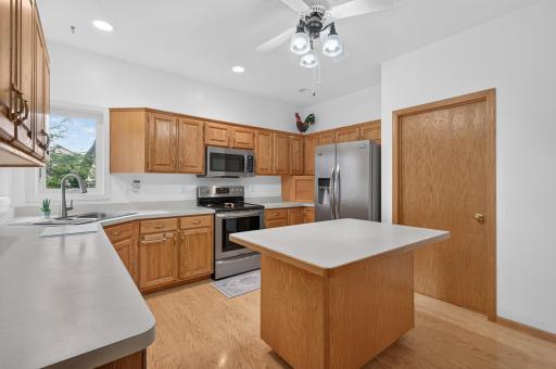 Another view of the kitchen with appliance garage in corner, lazy Susan and doorway into the main floor laundry room.