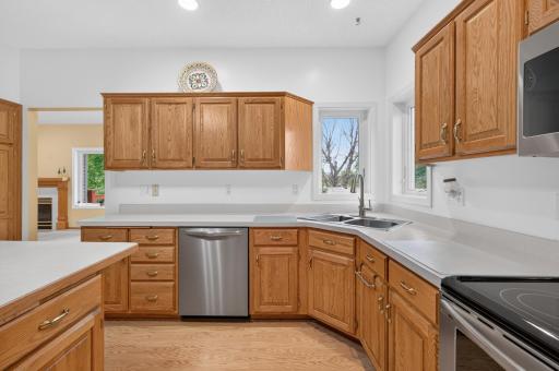Corner kitchen sink with split casement Andersen windows. Recessed lighting, ceiling fan and easy care laminate flooring.