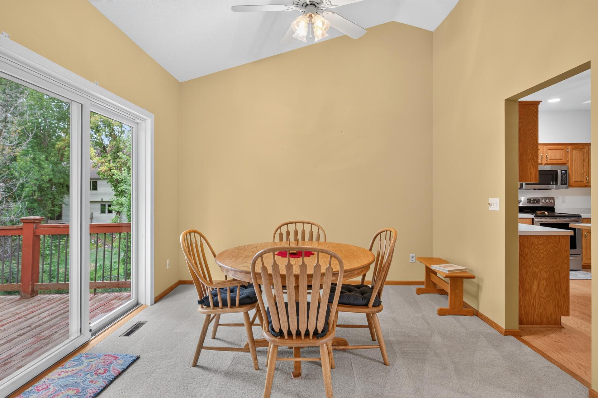 Nice sized vaulted dining area with a sliding glass door out to a deck.