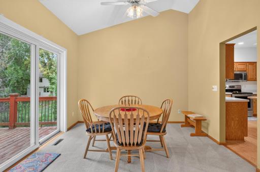 Nice sized vaulted dining area with a sliding glass door out to a deck.