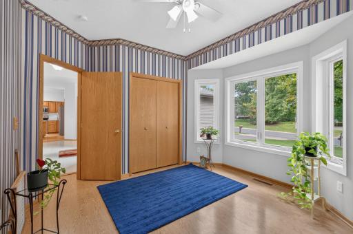 Another view of front bedroom/office with laminate flooring and 2 wide bi-fold closet.