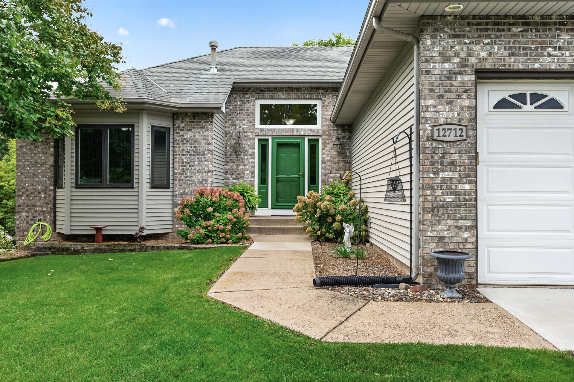 Attractive front elevation with lots of brick, angled bay window and a 1.5 story entryway.