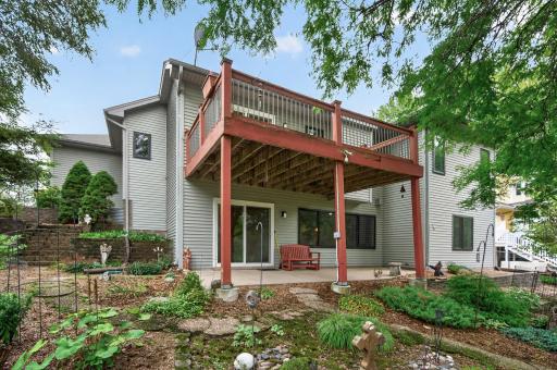 A view of the back of the home with lots of greenery, plantings and mother nature. Lots of peace and quiet in this backyard.