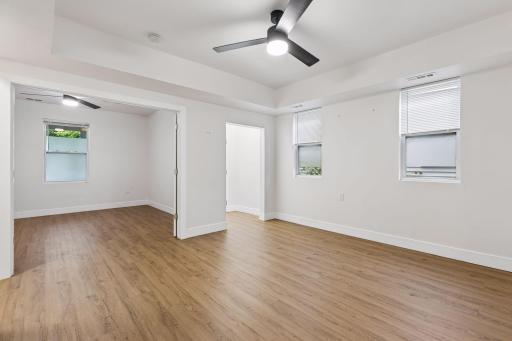 Unit 1: French doors connect the living room to the spacious main-floor bedroom, creating an easy flow between the two spaces.