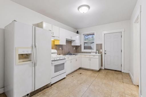 Unit 2: The kitchen features a practical layout with ample cabinet and counter space, providing a great opportunity for future improvements.