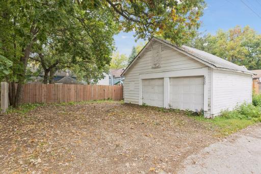 Two garage spaces provide convenient parking, with additional parking available off the alley for added flexibility.