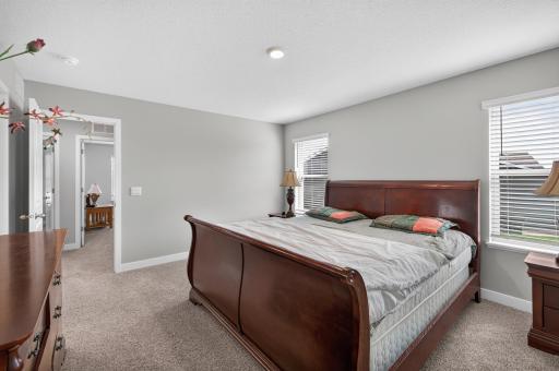 Retreat to the spacious primary suite, offering a comfortable layout, soft neutral finishes, and natural light. A relaxing space to unwind at the end of the day!