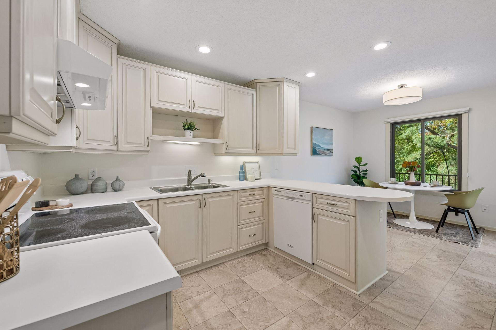 Kitchen conveniently opens to the remodeled deck with newer Andersen patio door, new railings in 2025 and Trex decking in 2020.