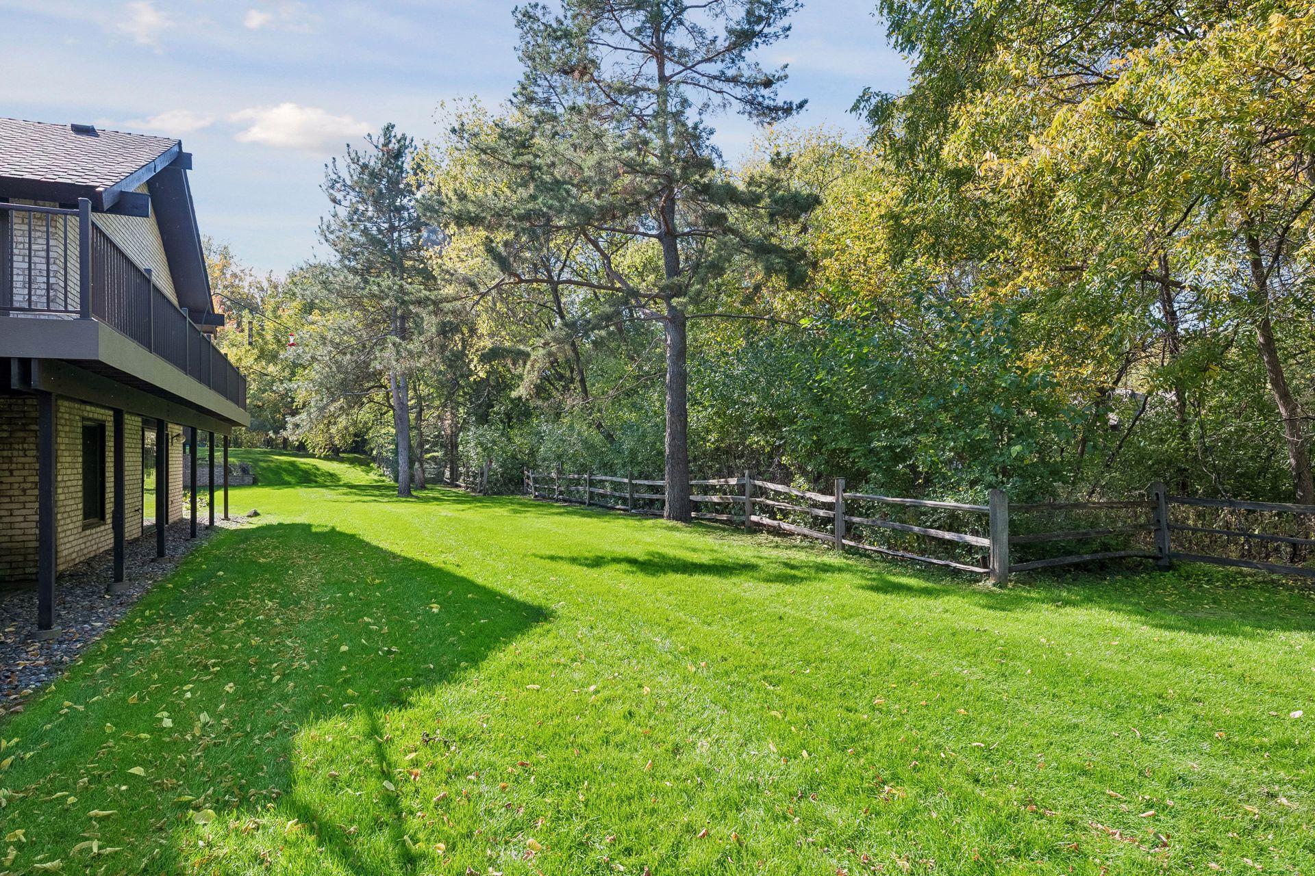 Wraparound deck overlooks the private backyard.