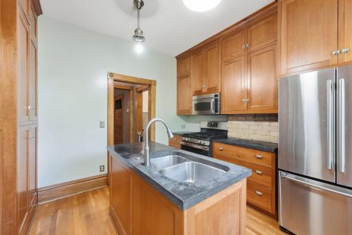 Newer maple cabinets with brick backsplash