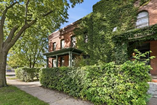 Character-filled brick exterior surrounded by lush greenery