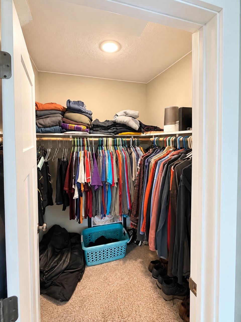 Primary Walk In Closet with more room behind door