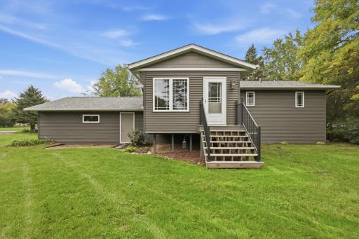 Overlooking the spacious backyard, the sunroom offers direct access to the yard, new steps and rails, and built-in speakers with Yamaha receiver.