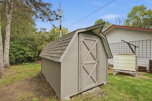 Inside the garage, you'll find built-in storage cabinetry, freshly painted walls and floor, and a Griprock-coated floor for easy maintenance. This recently painted storage shed provides additional storage.