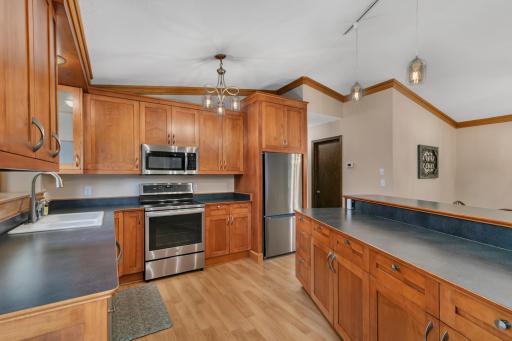 A vaulted ceiling, ceiling fan, updated lighting, and knockdown ceiling texture add to the inviting feel of the space.