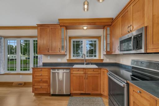 The custom cabinetry features a clean flush-mount design, complemented by stainless steel appliances that will remain with the home.