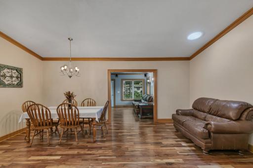Just off the kitchen, the dining area is filled with natural light from a distinctive circular skylight and features beautiful hardwood flooring.