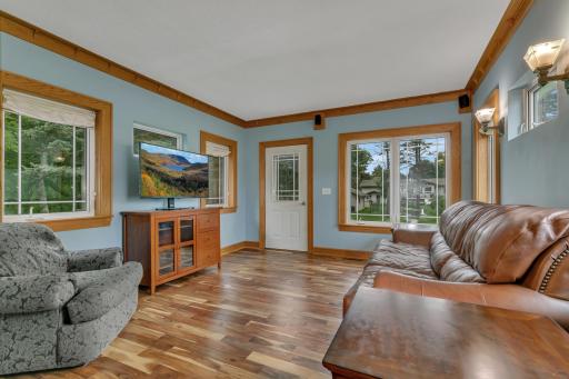 The sunroom overlooks the expansive backyard and offers direct access through a backyard door with newly rebuilt steps and railings.