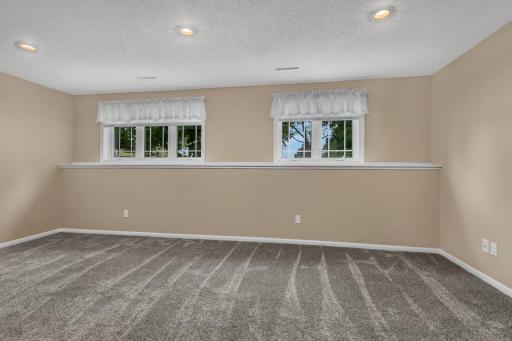 The lower level expands the living space with a comfortable family room. Knockdown ceiling texture, updated lighting, and recessed lighting give the lower level a finished and welcoming feel.