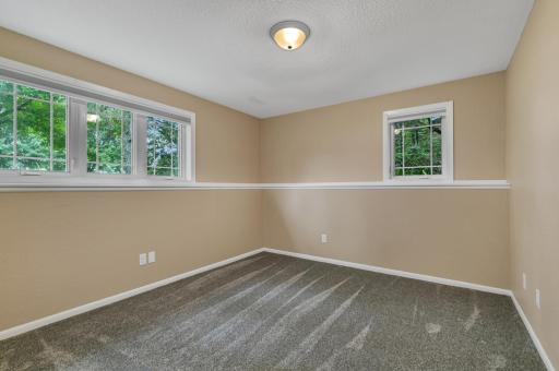 Both lower level bedrooms feature knee-wall storage/display areas, new carpeting, fresh paint, and painted trim.
