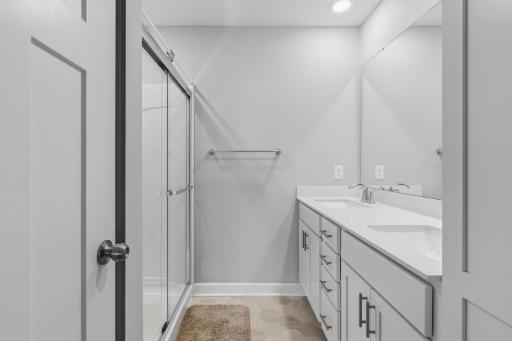 Primary bathroom with double vanity and additional storage