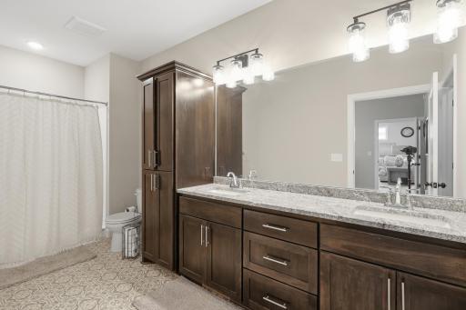 Main Level Primary Full Bathroom with Dual Sinks and Walk in Closet