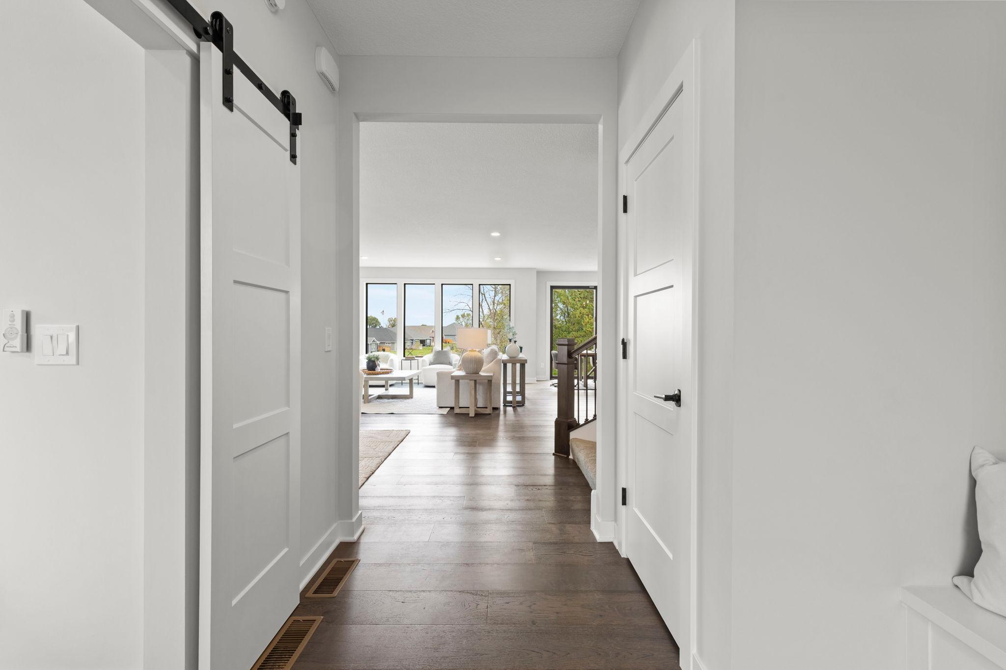 The welcoming foyer features a spacious hall closet and built-in bench, creating a practical and inviting entry.