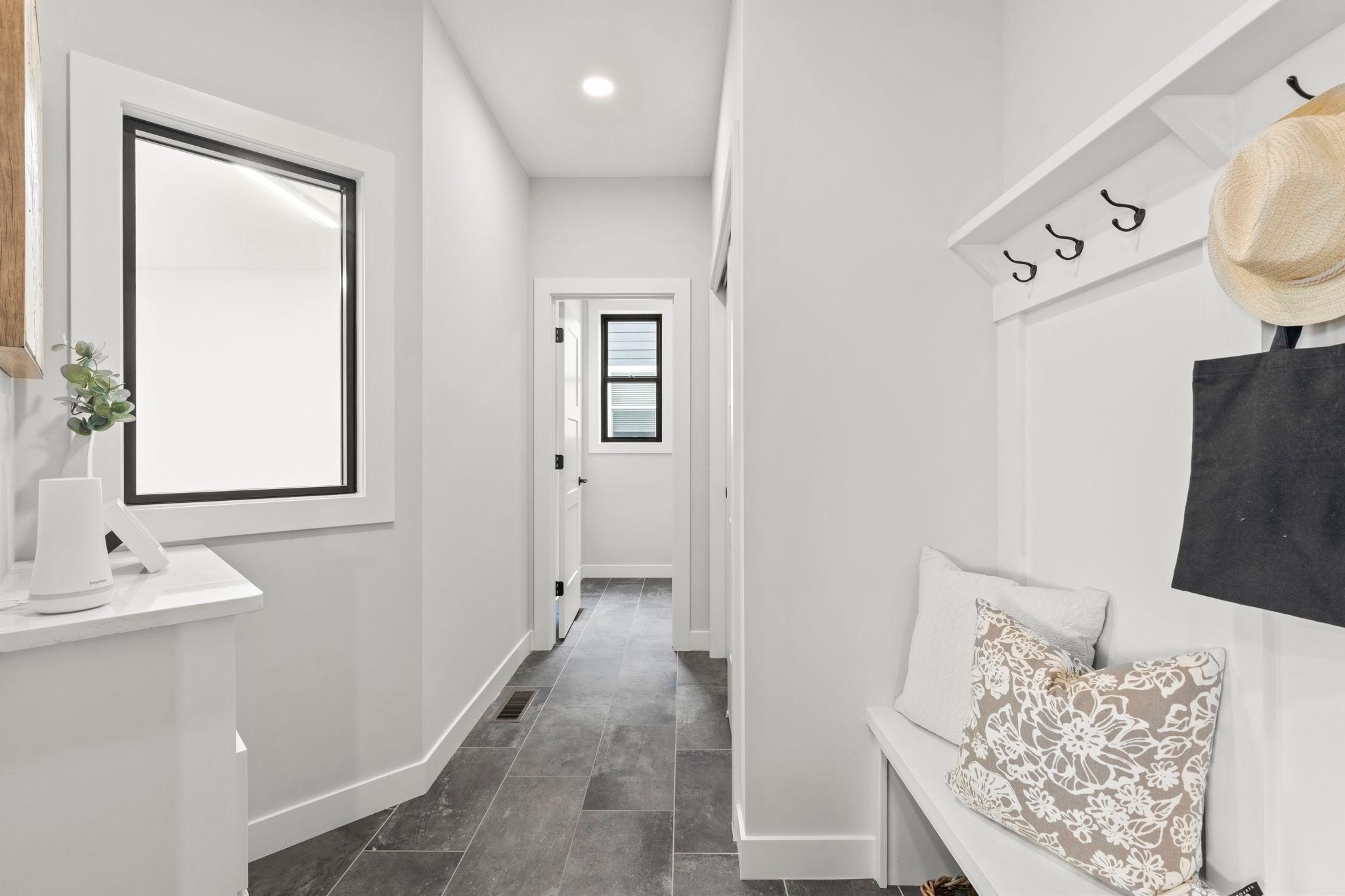 Another look at the mudroom entrance, with access to the half bathroom and a window overlooking the lower-level sport court and fitness room.