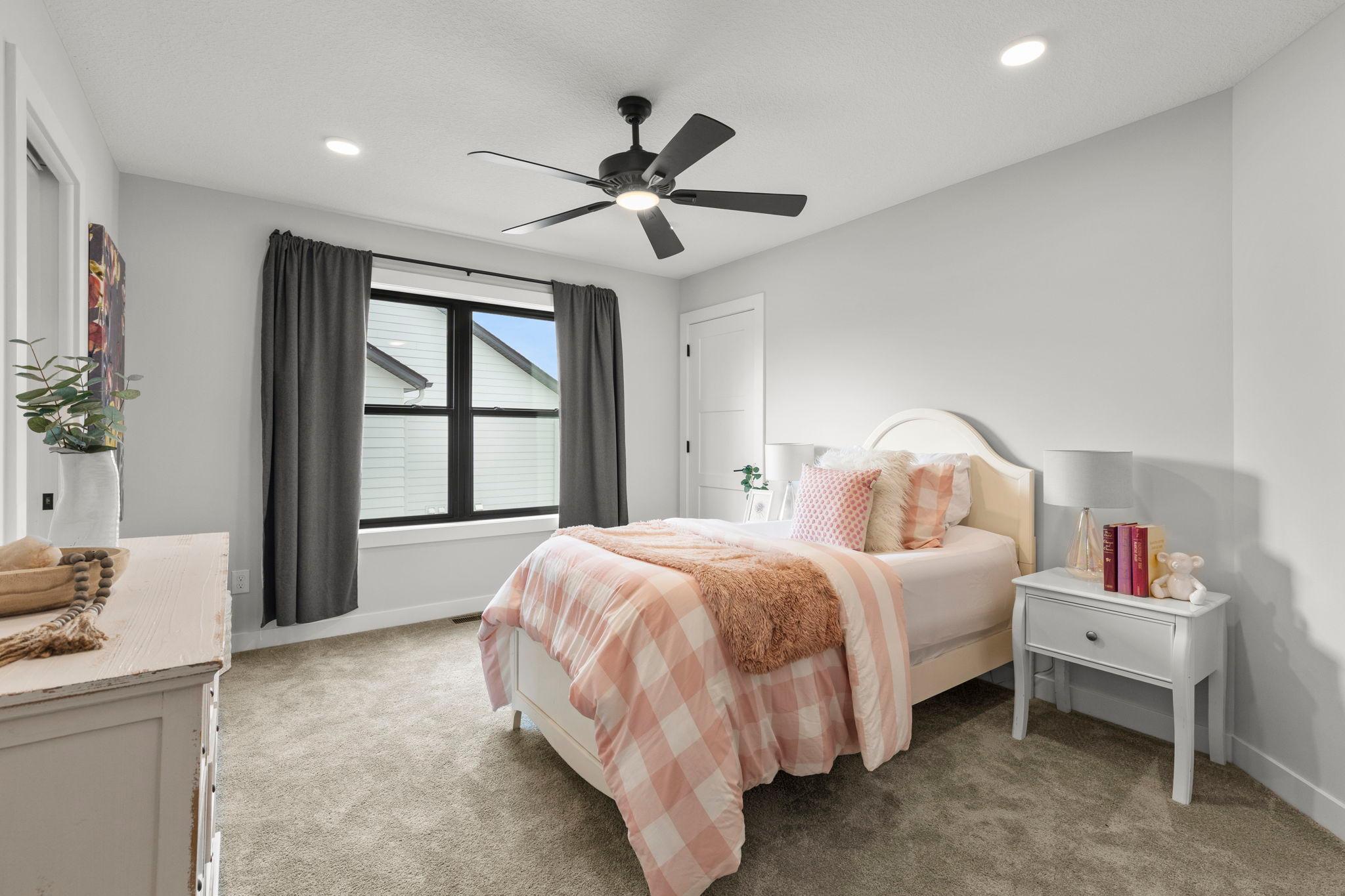 Bedrooms two and three are similar in size and feature carpeting, ceiling fans, walk-in closets, and access to a shared Jack-and-Jill full bathroom.