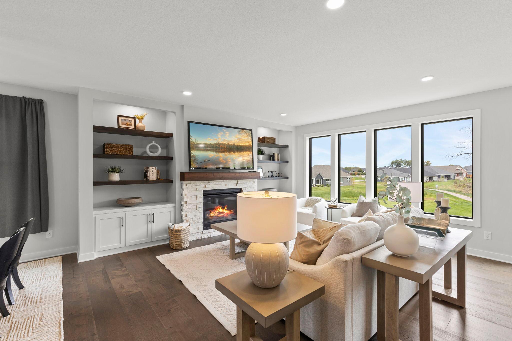 Adjacent to the dining areas, the spacious, comfortable, and stylish living room offers a welcoming space to relax and gather.