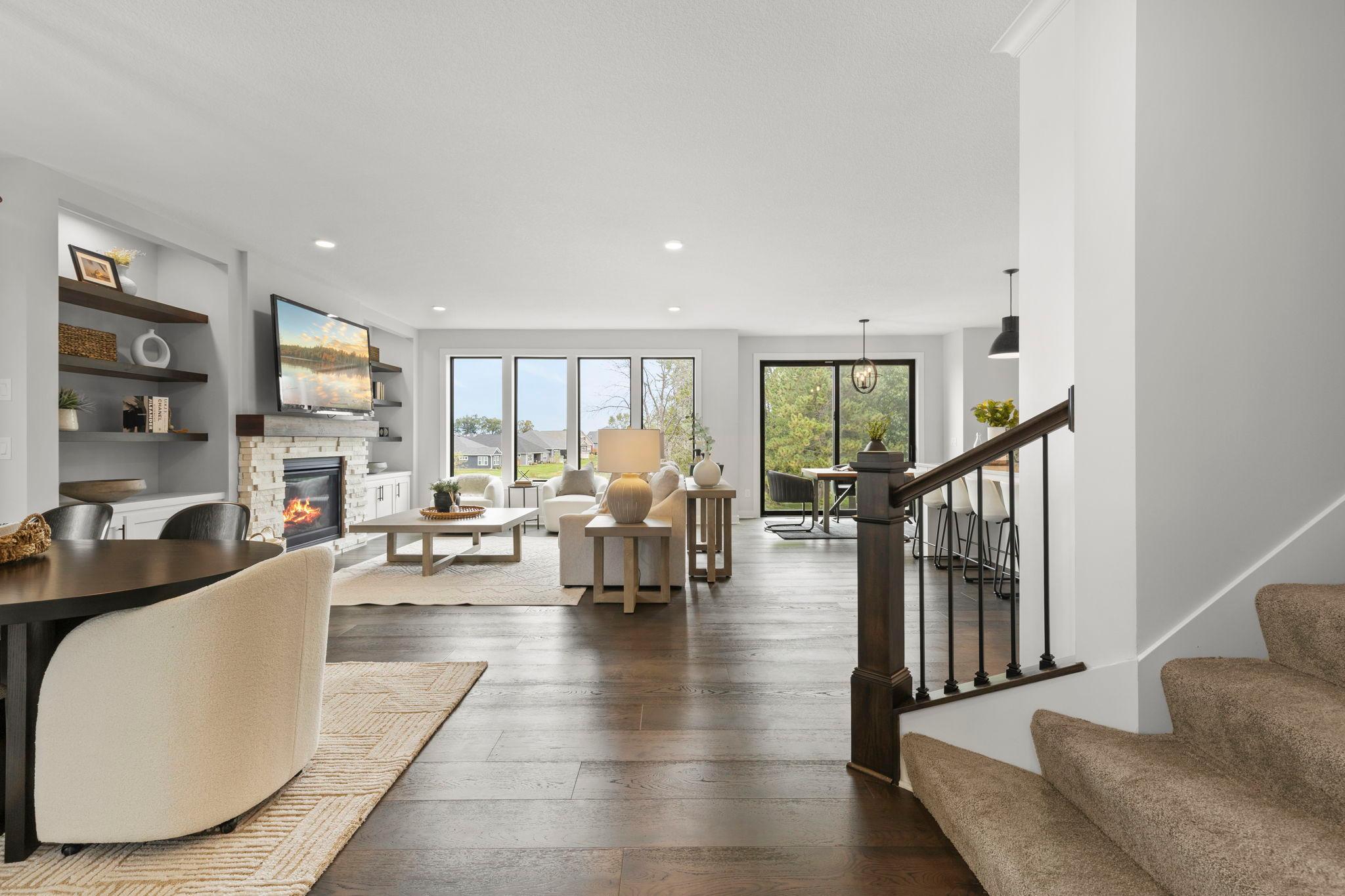 Step inside to a light-filled, open-concept main level with beautiful warm hardwood flooring flowing throughout.