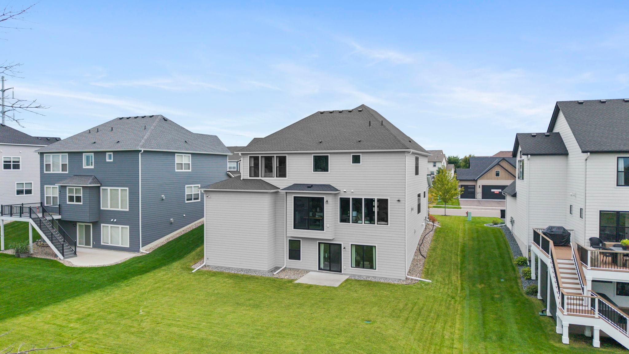 A rear exterior view of the home, showcasing the expansive backyard and attractive architectural details.