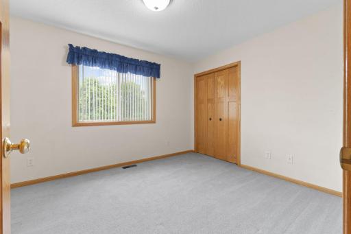 The upper-level bedroom offers a bright and welcoming retreat, filled with natural daylight and beautiful backyard views. Attractive paneled doors add timeless character, while layout provides the perfect space for family, guests, or home office.