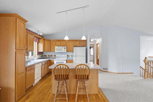 Filled with natural daylight, vaulted ceilings and a spacious kitchen with a center island, creating an inviting atmosphere perfect for everyday living and entertaining. Just off the dining room, step into the charming 3-season porch.