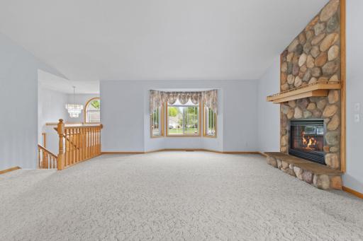 The open and spacious living room offers an inviting atmosphere with abundant natural daylight and soaring vaulted ceilings.