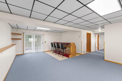 The spacious walkout family room is designed for both relaxation and entertaining, featuring a built-in bar and direct access to the patio. With plenty of room for gatherings, movie nights, or game-day celebrations.