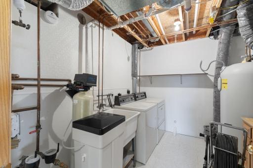 The utility room offers added convenience with an included washer and dryer, as well as a laundry tub for household tasks and clean-up. With ample space for laundry & additional storage, this functional area helps keep everyday living organized.
