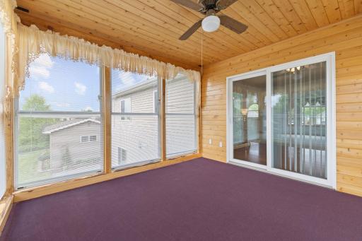 Charming knotty pine 3-season porch provides a warm and inviting retreat to relax and enjoy views of the quiet backyard. Filled with natural light and rustic character, this cozy space is perfect for morning coffee or entertaining guests.