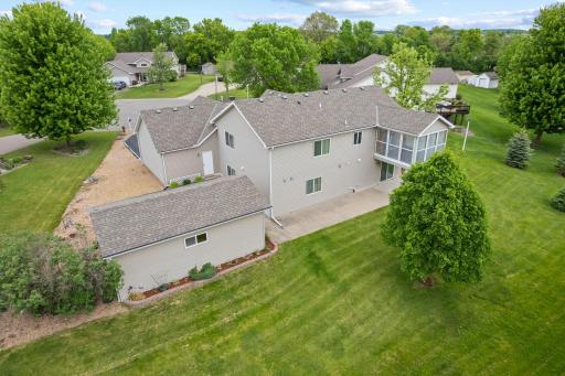 This view of the backyard showcases the home's well-maintained outdoor space and peaceful setting. Mature landscaping, ample green space, and a private atmosphere create the perfect backdrop for relaxing or entertaining.
